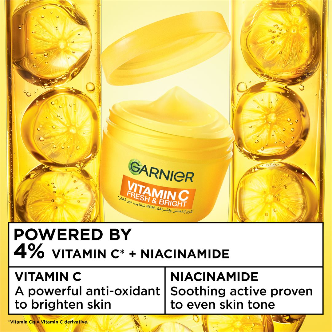 Garnier Vitamin C Fresh & Bright cream jar in a bright yellow-gold liquid with lemon slice graphics and text highlighting vitamin C and niacinamide benefits.