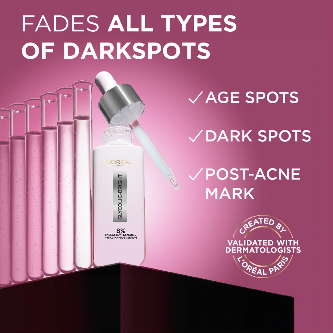 L'Oreal serum bottle with dropper on a pink background, highlighting dark spot-fading properties.