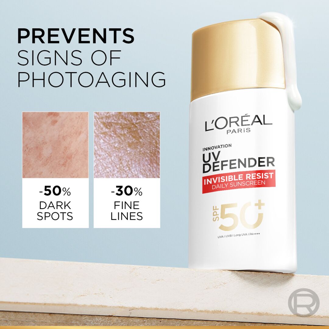 L'Oreal UV Defender sunscreen bottle with anti-aging benefits on a light blue background